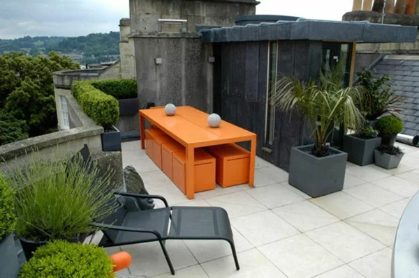 dachterrasse gestalten farbakzente in orange balkon möbel hecke balkonpflanzen