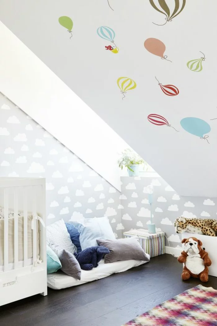 kinderzimmer mit dachschräge babyzimmer babybett kuschelecke spielecke kuscheltiere luftballon wandtapete wolken