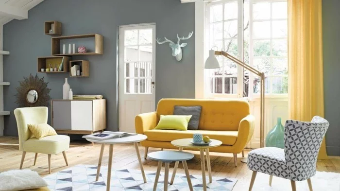 skandinavisch wohnen wohnzimmer gelbes sofa runde beistelltische geometrischer teppich
