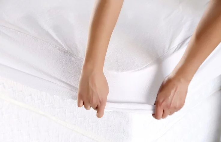 Female hand pulling white sheets