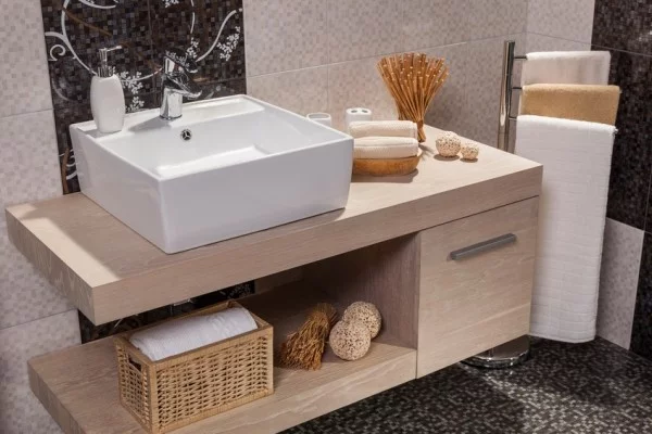 detail of a modern bathroom with white sink and towels