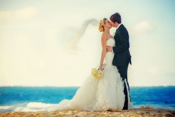 Bride and Groom Kiss on the Beach