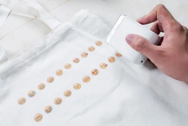 PrinCube ist ein winziger Handdrucker, der auf jeder Oberfläche drucken kann drucken auf stoff einkaufstasche